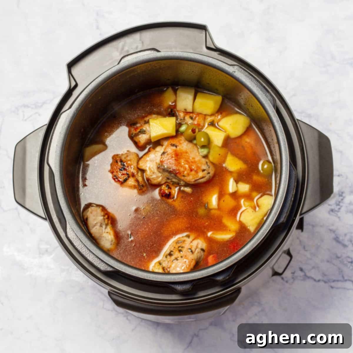 Instant Pot Chicken Stew cooking with seared chicken to the pot