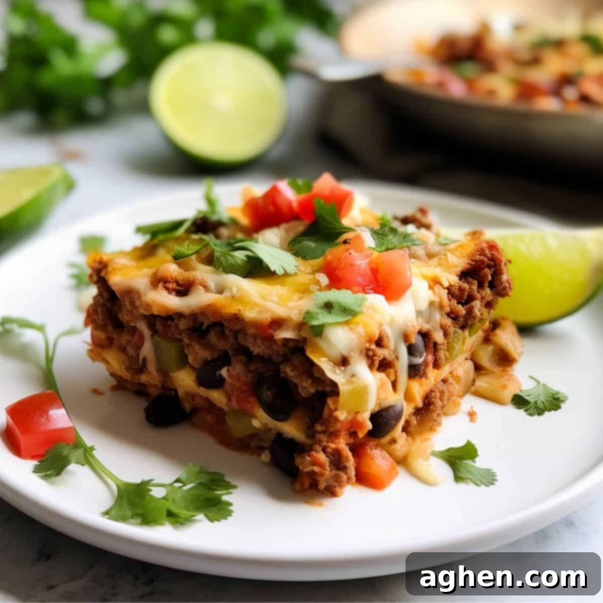Your Go To Weight Watchers Mexican Casserole for Weeknights 2 slice of healthy mexican casserole on white plate with lime wedge