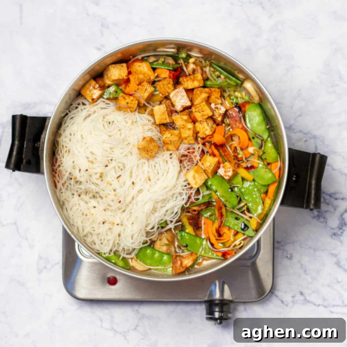 Dangerously Delicious Weight Watchers Thai Noodles 8 Combining cooked vegetables with tofu, chicken, and rice noodles in a large skillet