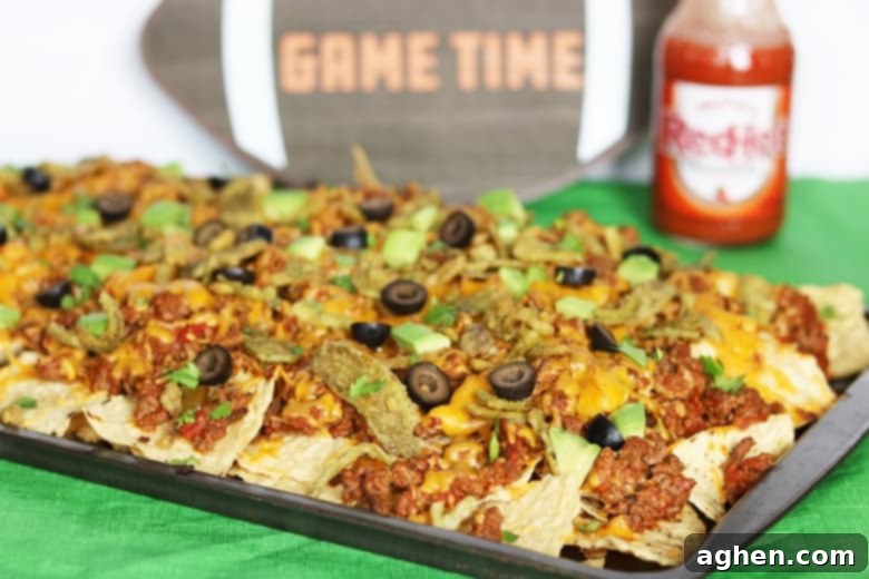 An easy loaded nachos recipe made in the oven. These baked nachos are packed with ground beef, cheddar cheese, and FRENCH'S™ Crispy Jalapeños.