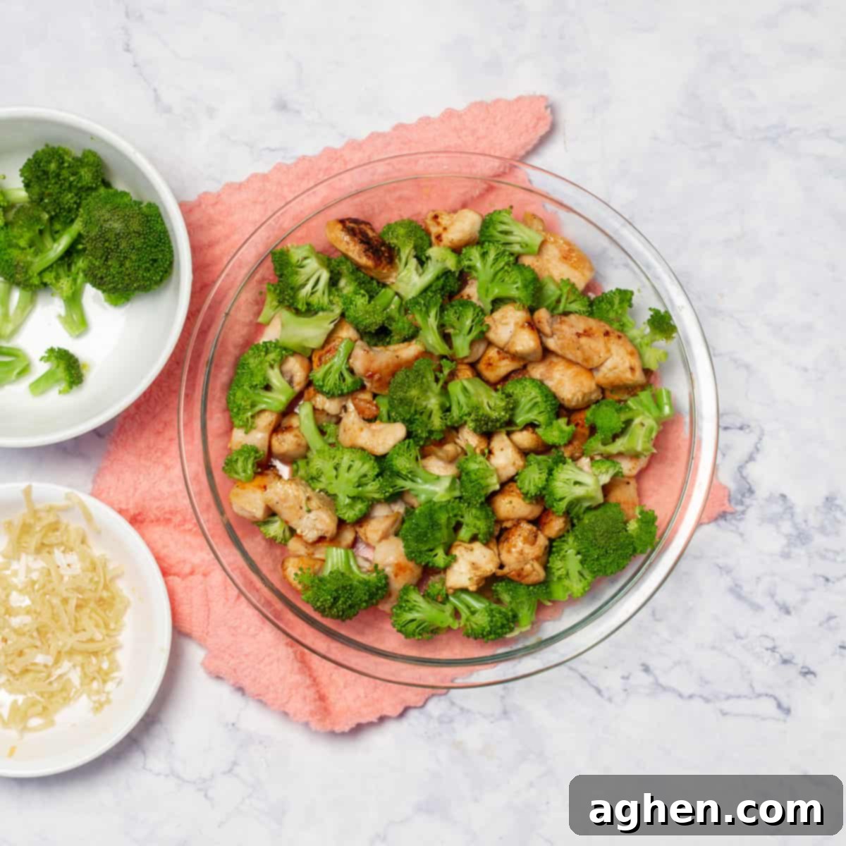 Skinny Chicken Divan Perfection 5 Assembling Chicken Divan in a baking dish with chicken, broccoli, and cheese sauce.