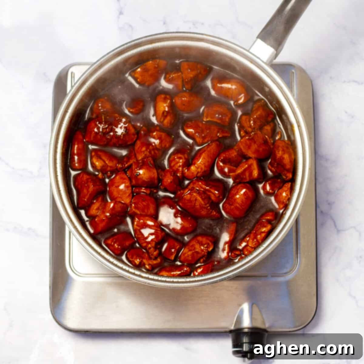 Weight Watchers' Beloved Chicken Teriyaki 7 Chicken simmering in teriyaki sauce in a skillet, thickening and melding flavors