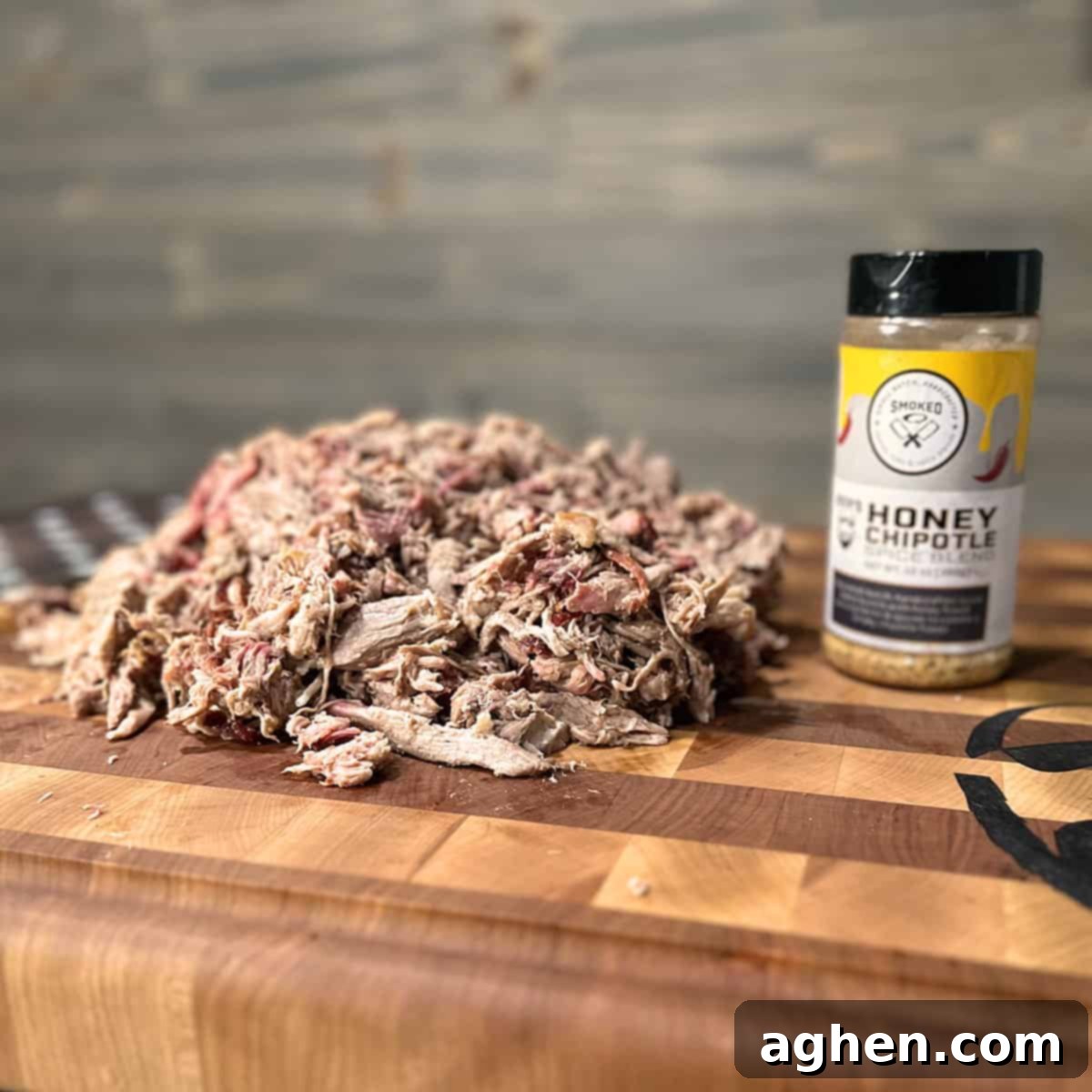 Signature Traeger Pulled Pork 2 A perfectly smoked pork butt resting on a cutting board, ready to be pulled, showcasing a dark, delicious bark.