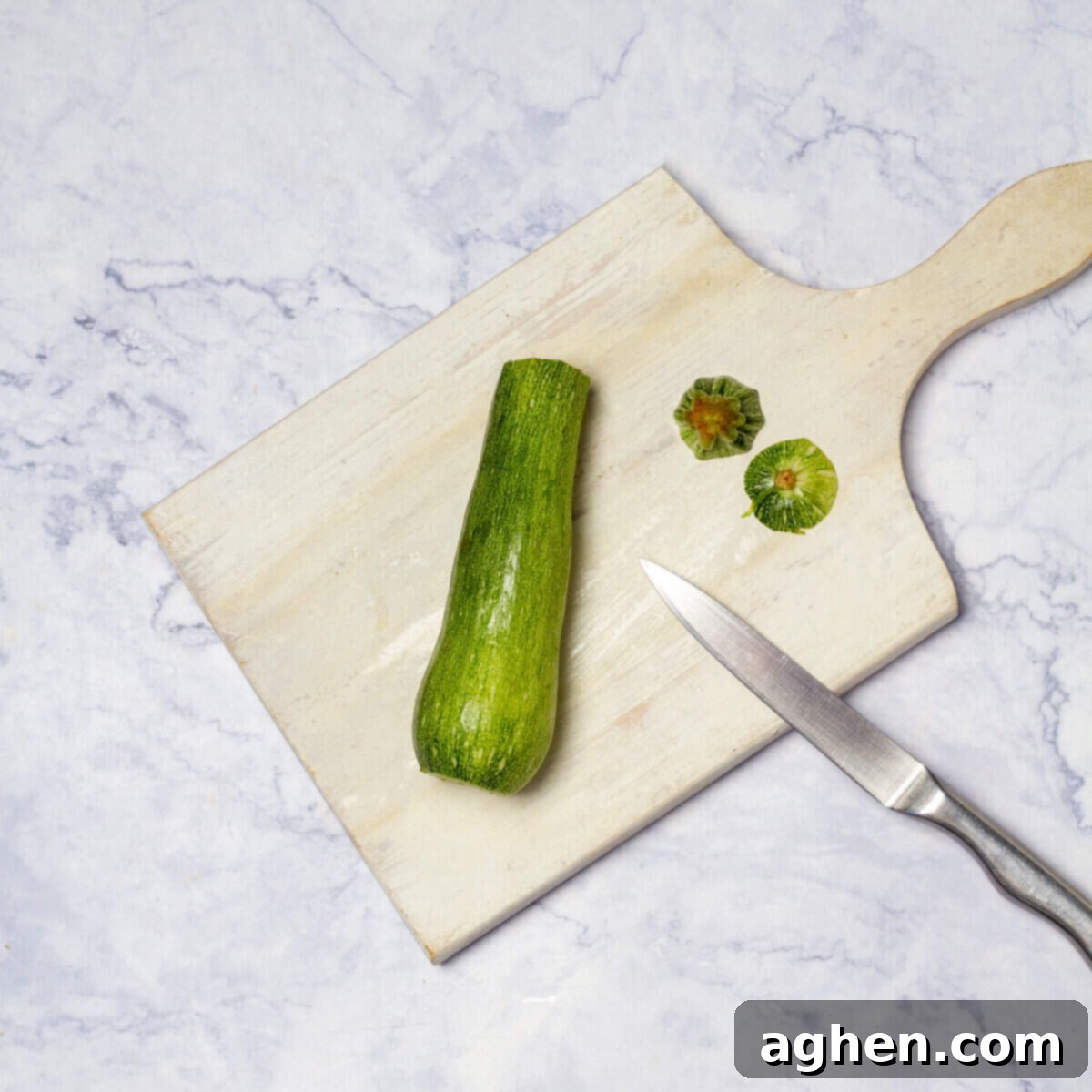 Zucchinis stem cut off on chopping board