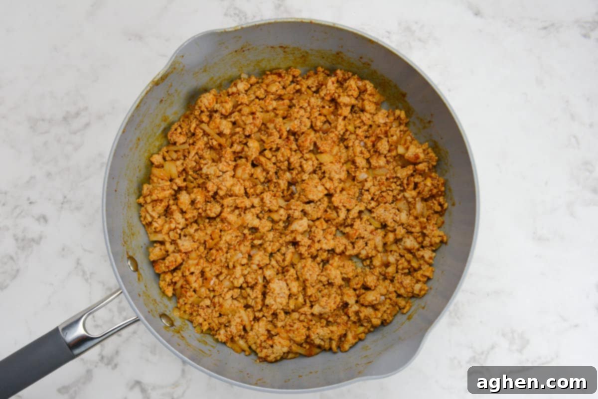 Indulge in Doritos Casserole on Weight Watchers! 5 Taco seasoning now coats the chicken and makes it a reddish brown color.