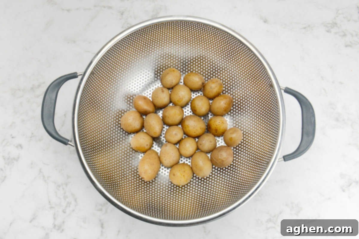 Crispy Blackstone Smashed Potatoes 5 boiled and tender baby potatoes cooling in a strainer