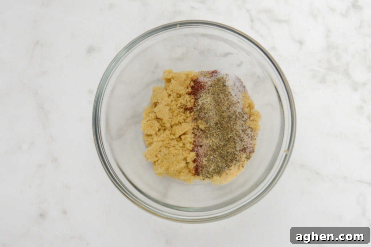 Blackstone'da Domuz Pirzolası 7 Kolay Adımda 5 dry rub ingredients for blackstone pork chops mixed in a small bowl