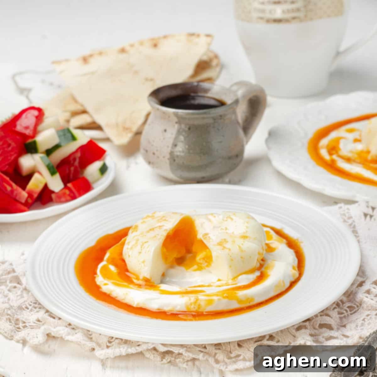 Perfectly poached Turkish Eggs (Cilbir) on creamy lemon-garlic yogurt, drizzled with a rich paprika butter sauce.