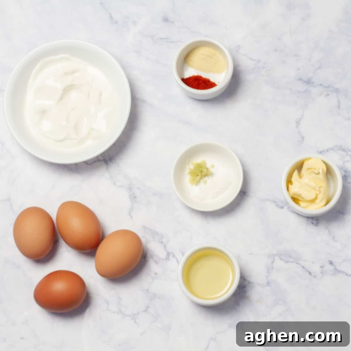Ingredients for Cilbir (Turkish poached eggs): fresh eggs, plain Greek yogurt, paprika, garlic, lemon zest, butter, and red pepper flakes.