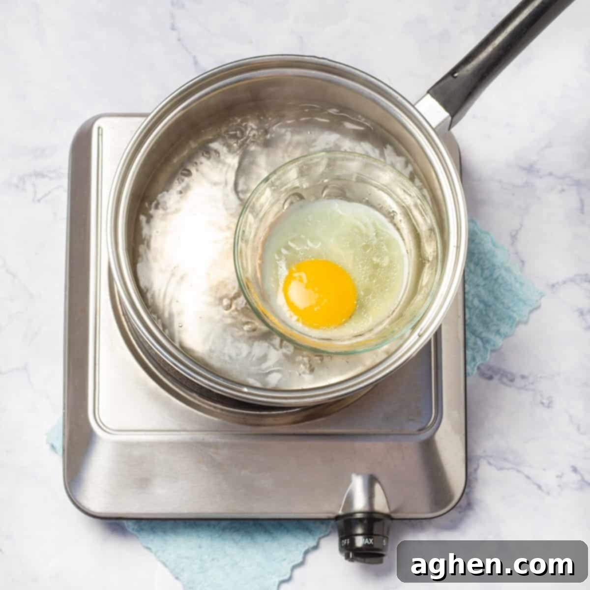 Poach an egg using the simple glass dish method in simmering water.