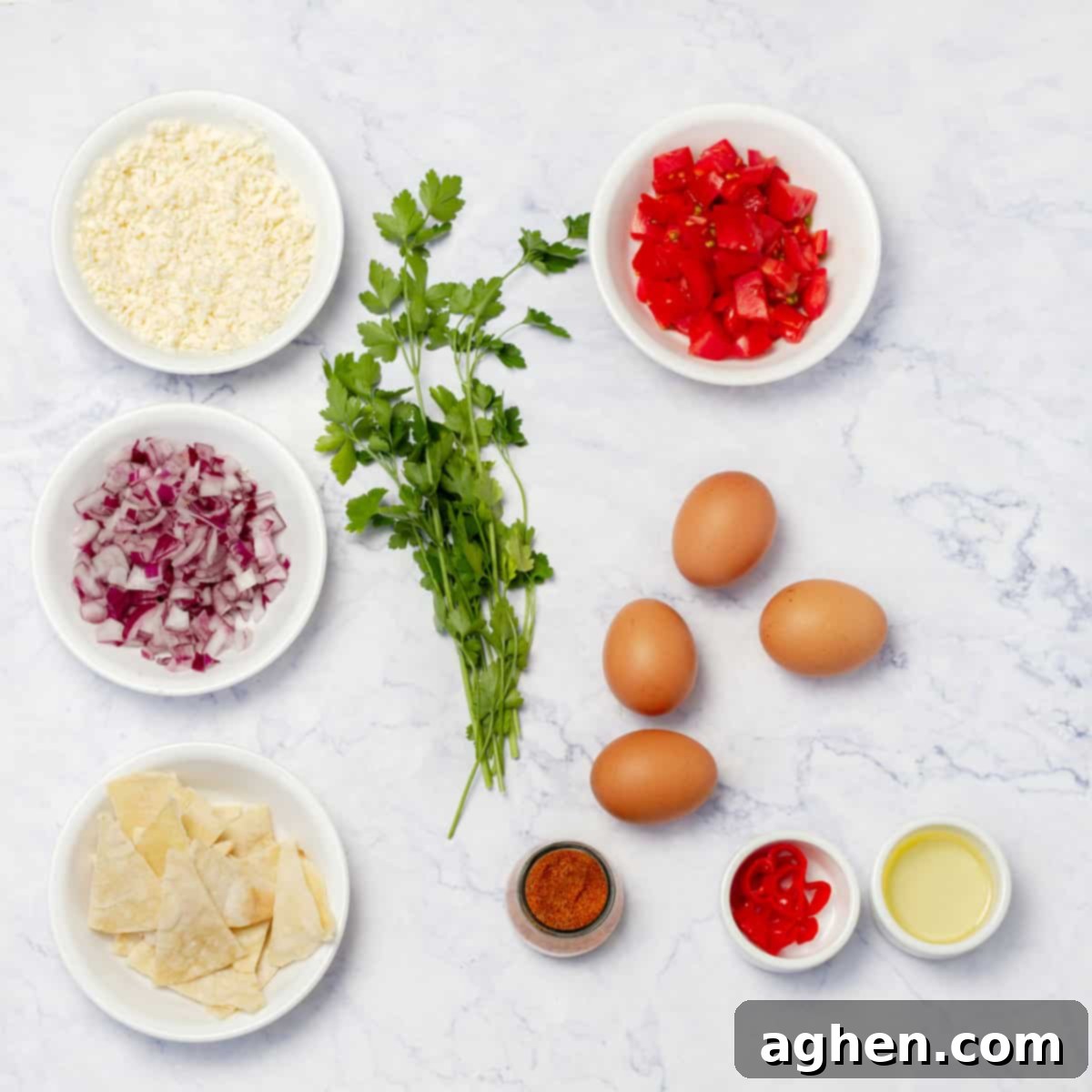 Classic Migas Gets a Healthy Makeover with Weight Watchers 3 Migas Tex Mex Breakfast ingredients, incuding eggs, tortilla crumbs, tomatoes, onion, cilantro, cheese, and Tex-Mex spices.
