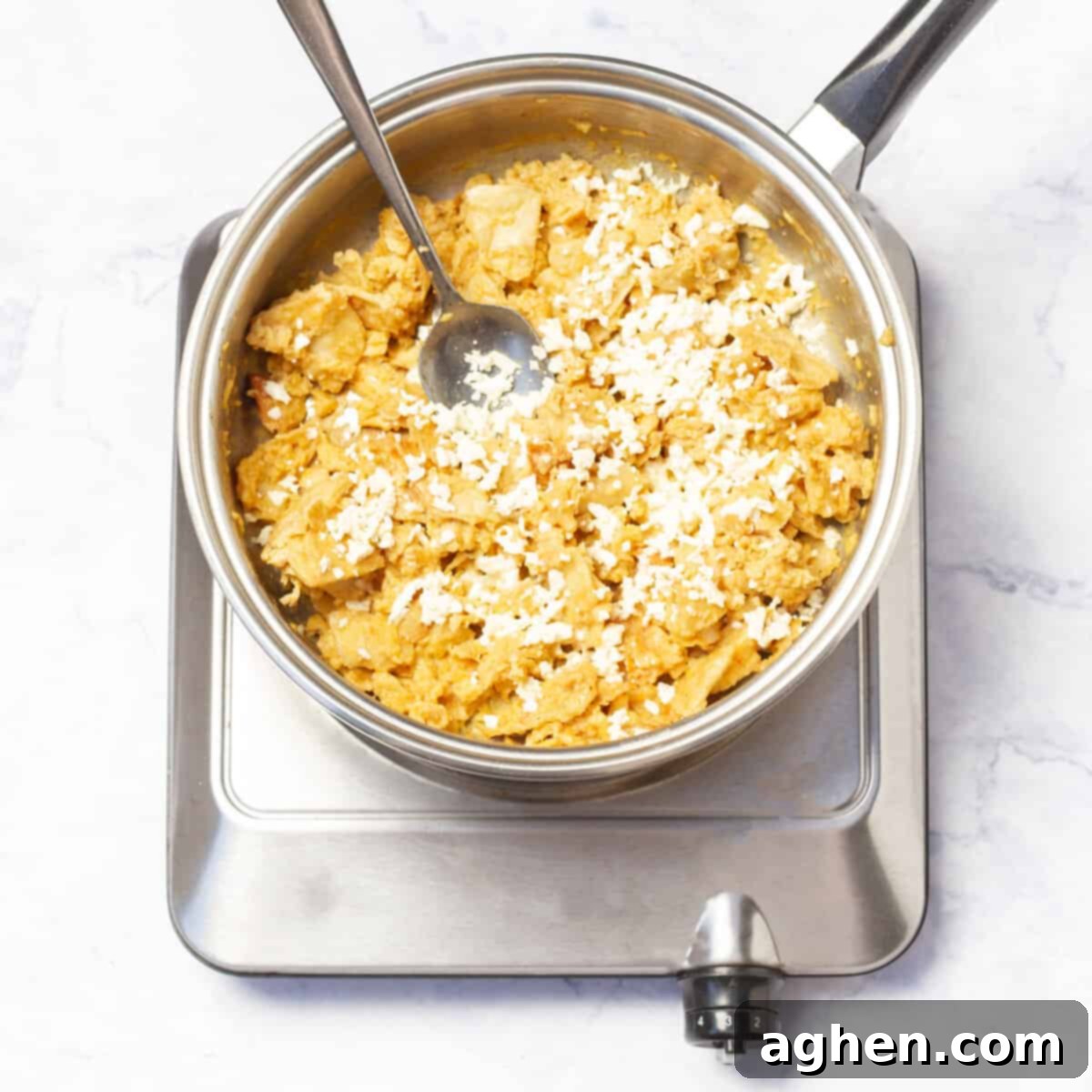 Classic Migas Gets a Healthy Makeover with Weight Watchers 7 Melt cheese into the tortilla and egg scramble.