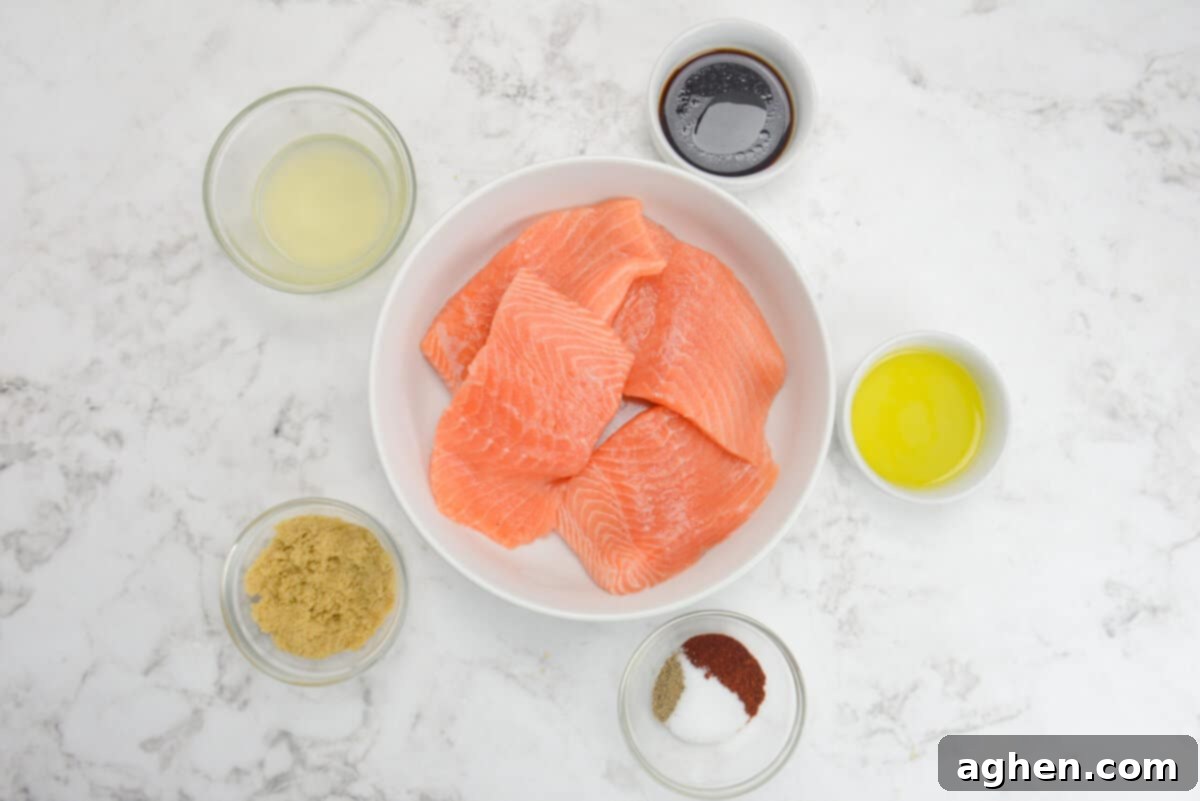 A vibrant selection of fresh ingredients laid out, including salmon fillets, various spices, pineapple juice, soy sauce, brown sugar, and olive oil, all ready for cooking delicious Blackstone salmon.