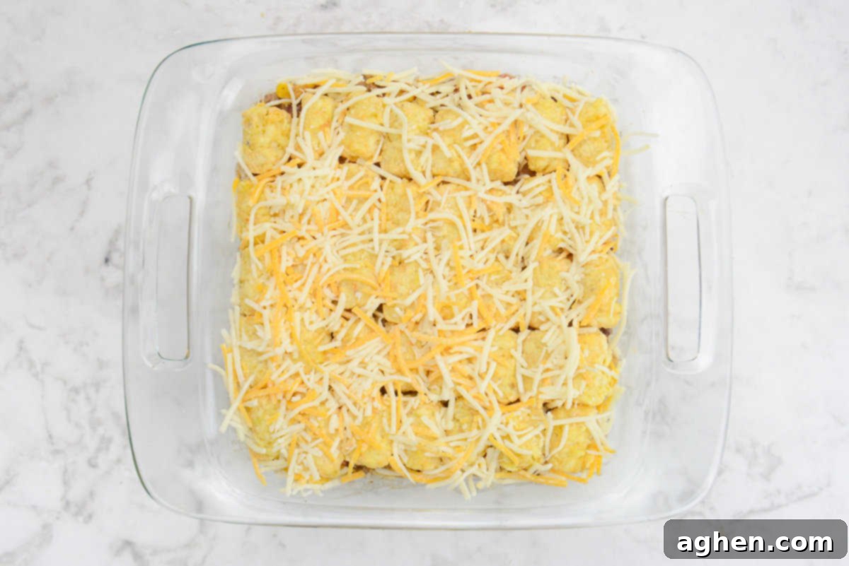 Guilt-Free Cowboy Casserole: A Weight Watchers Recipe You'll Love 11 A casserole dish is shown completely assembled and topped with white and orange cheese