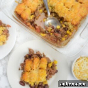 Guilt-Free Cowboy Casserole: A Weight Watchers Recipe You'll Love 13 A casserole dish is shown with two servings plated next to it. A bowl of cheese sits to the side.