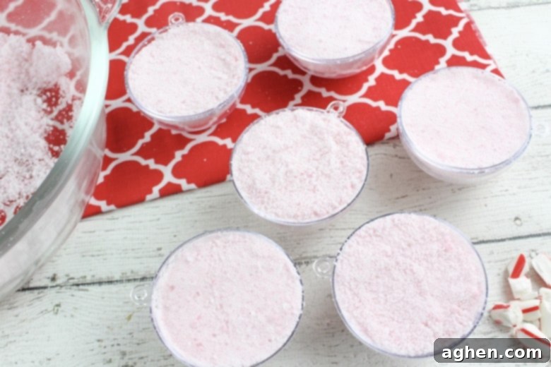 Press the bath bomb mixture into each mold, using a spatula to press it down as very as possible. 