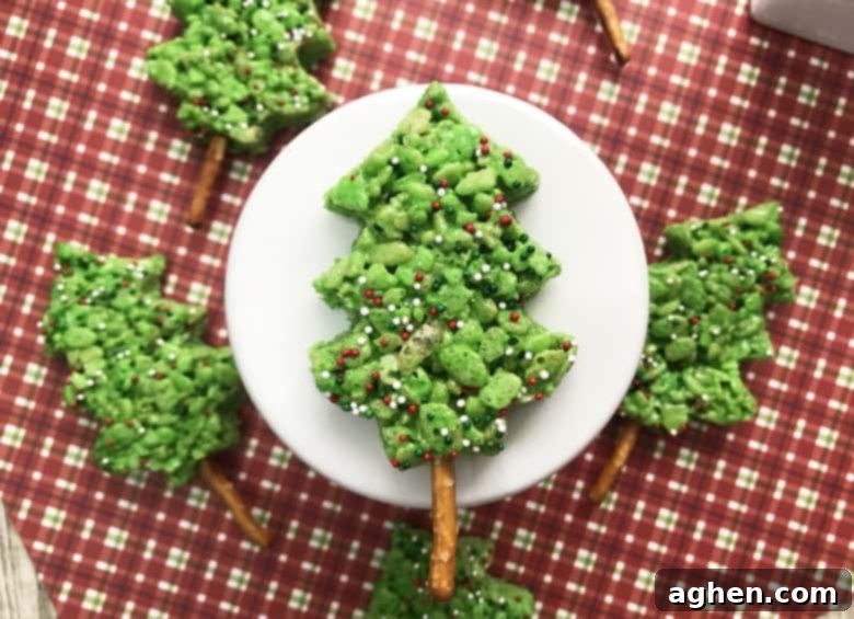 Easy to make green Christmas Tree Rice Krispie Treats decorated with sprinkles for a festive holiday dessert
