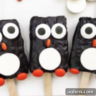Delightful Penguin Rice Krispie Treats made with store-bought treats, candy melts, and festive candies.