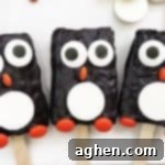 Delightful Penguin Rice Krispie Treats made with store-bought treats, candy melts, and festive candies.
