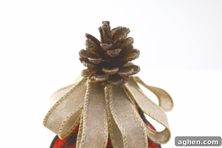 Multiple layers of burlap ribbon creating a beautiful DIY Christmas tree decoration.