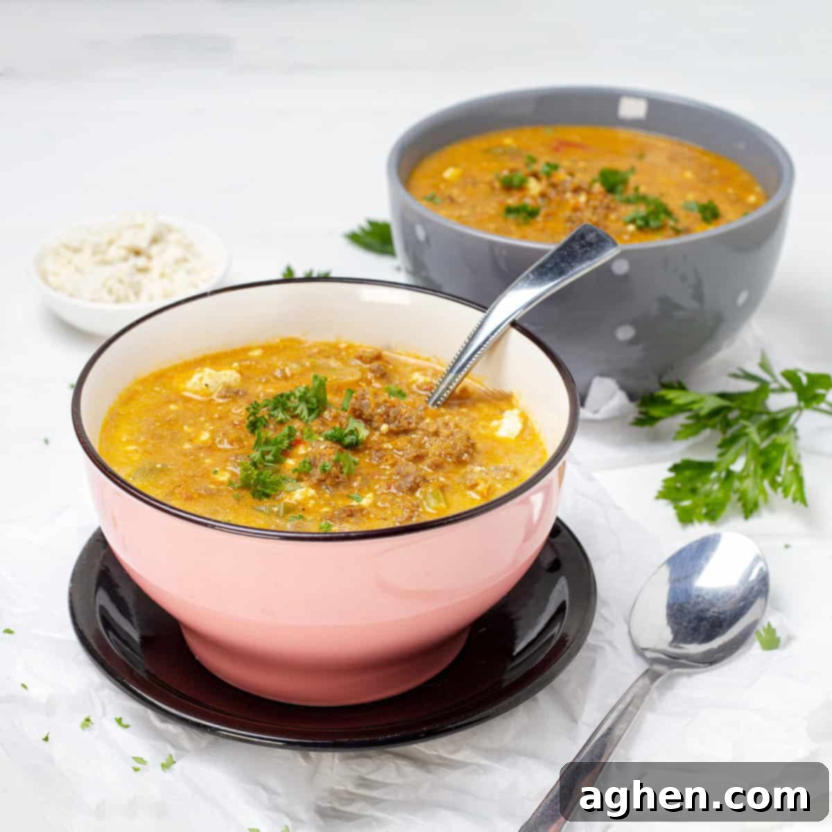 The Ultimate Weight Watchers Cheeseburger Soup 2 Cheeseburger Soup served in 2 bowls with glass of water