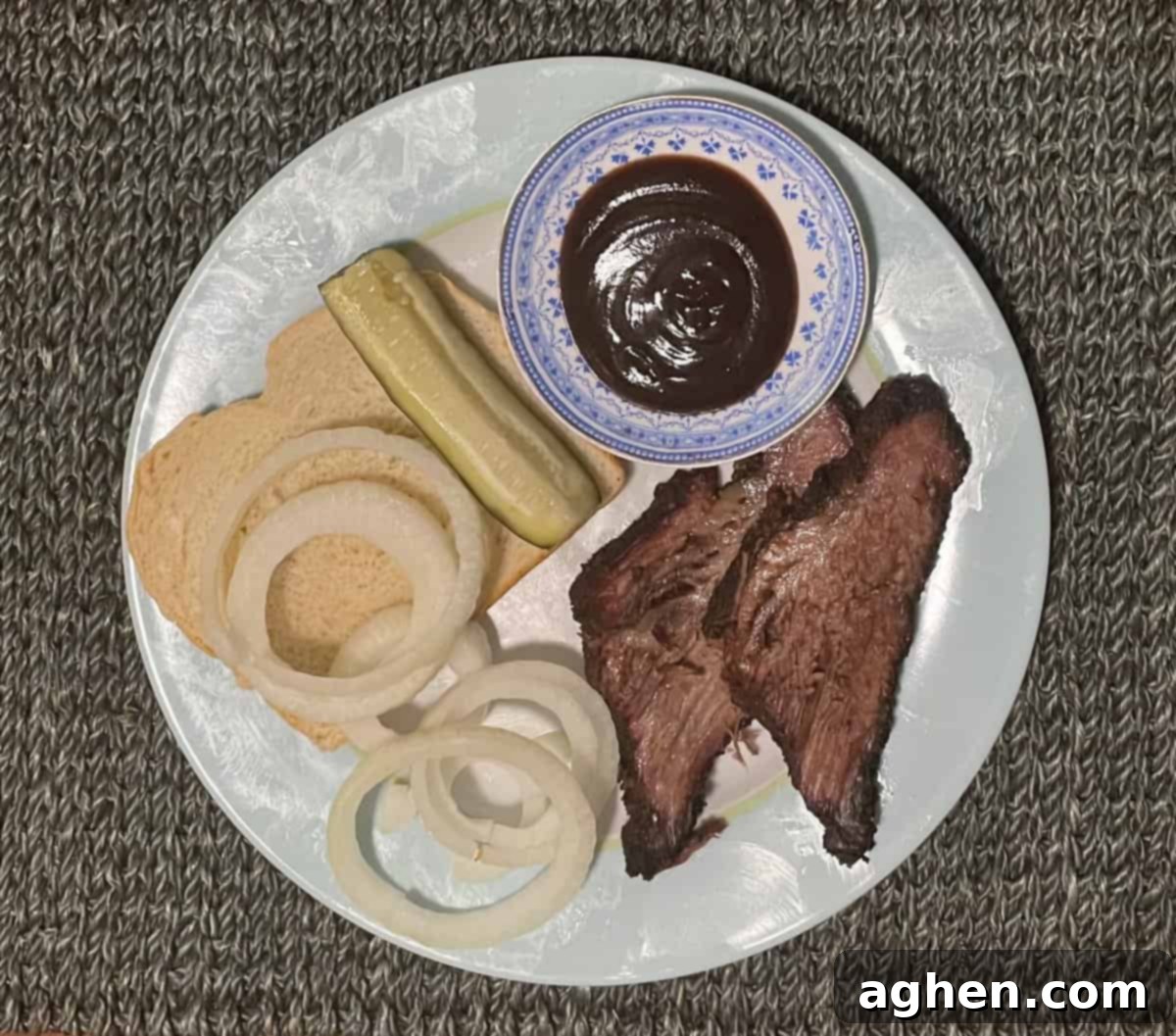 Aaron Franklin's Brisket: Can My Big Green Egg Handle It? 10 A plate of sliced brisket with white bread and onion slices