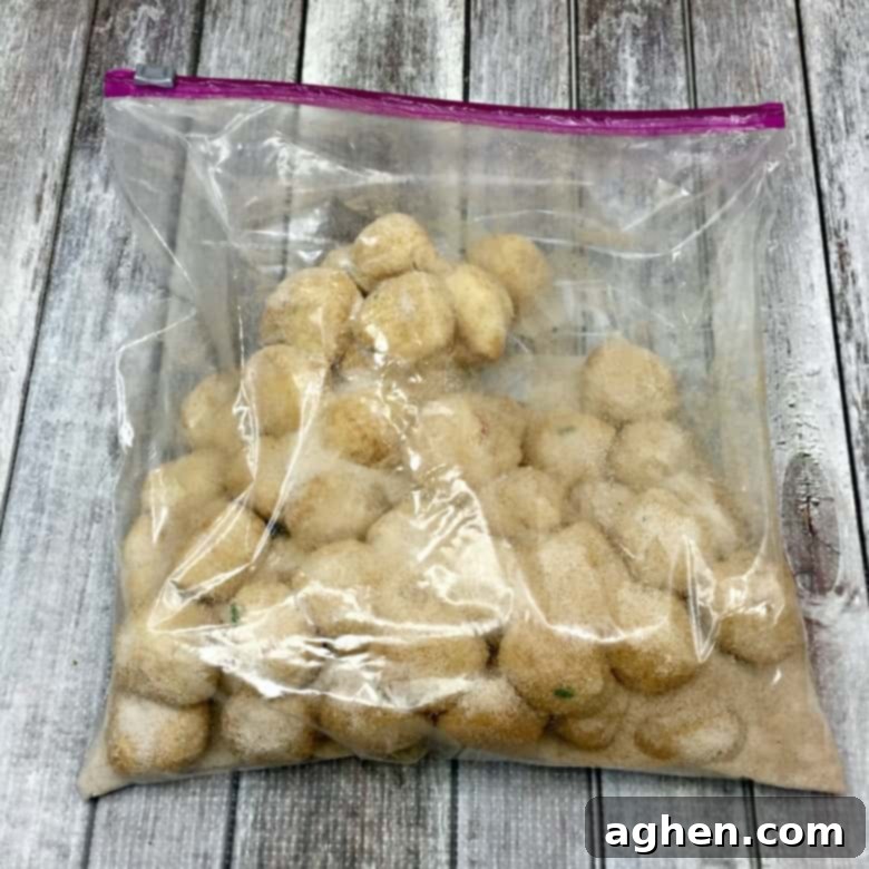 A large zipper bag filled with cinnamon, sugar, and several dough balls, illustrating the coating process for Christmas Monkey Bread.