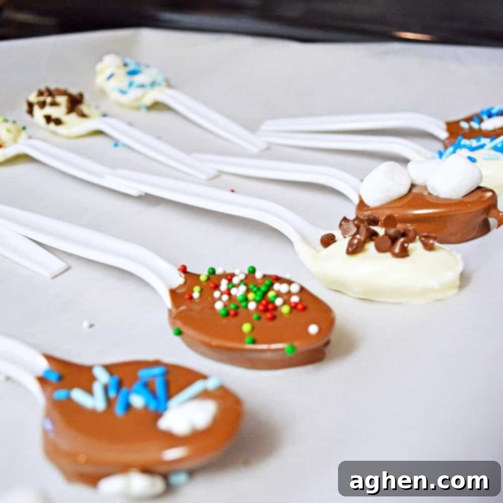 Chocolate dipped spoons setting on a parchment lined baking sheet