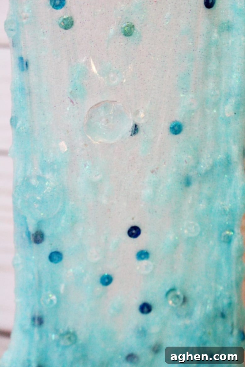 Vibrant Disney Frozen-themed snowflake slime with embedded charms and glitter, perfect for winter play