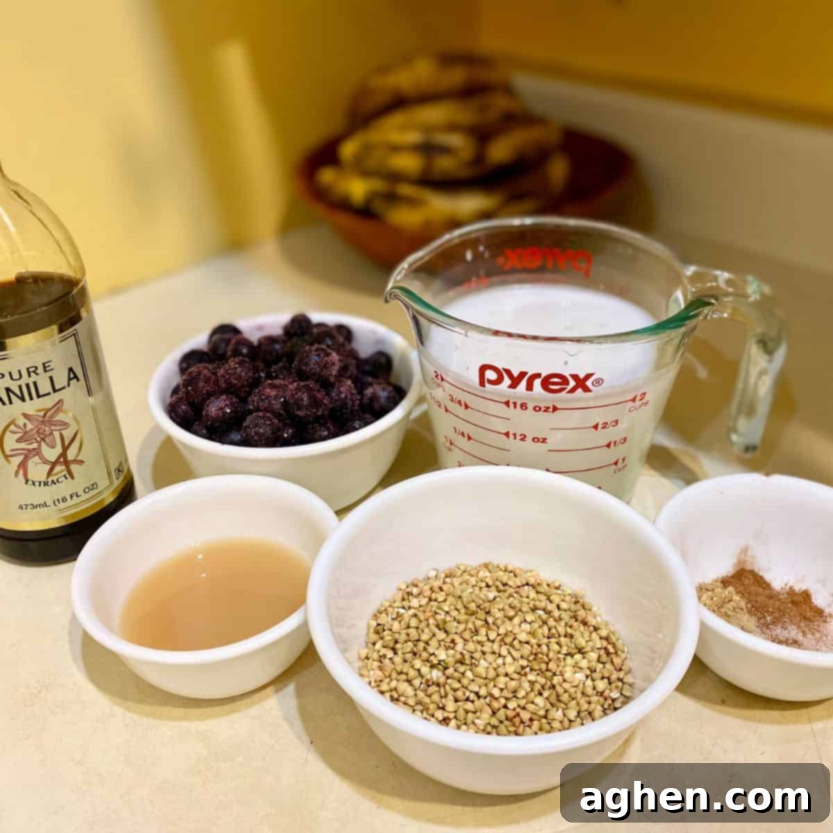 Sumptuous Buckwheat Porridge with Luscious Blueberry Compote 3 Buckwheat porridge and blueberry compote ingredients laid out: buckwheat groats, almond milk, various spices, fresh blueberries, lemon juice, stevia, and vanilla extract.