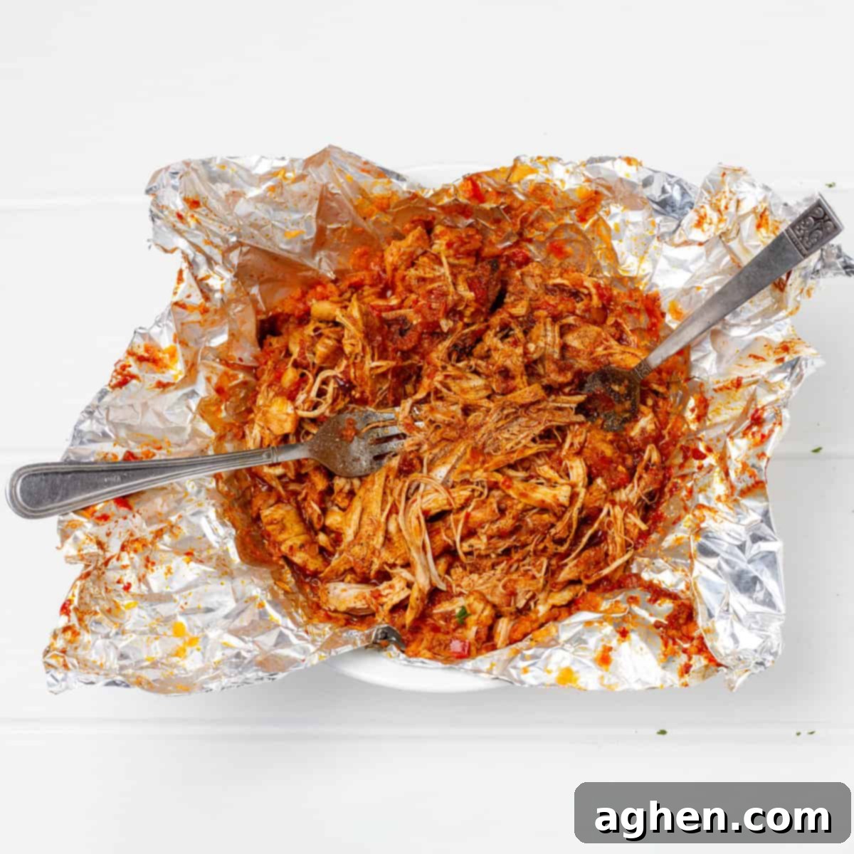 two forks to shred the chicken directly in the packet