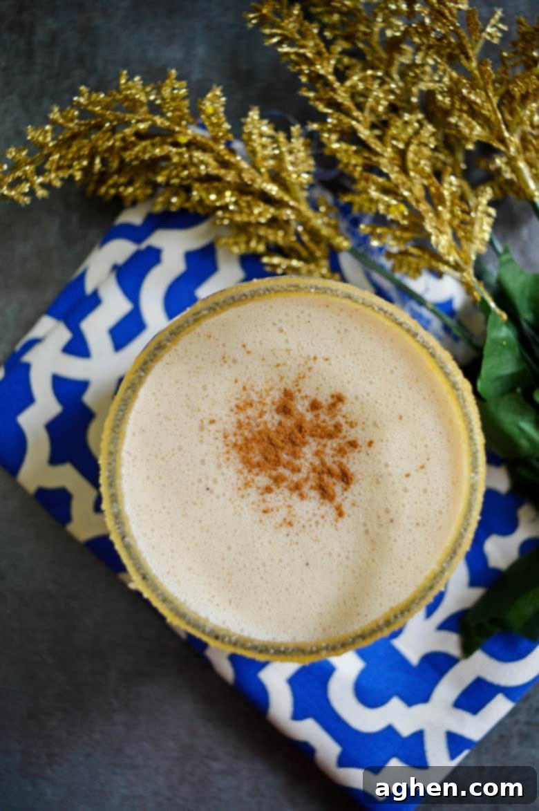 A rich and creamy, no-egg, coquito recipe made with rum and coconut milk, garnished with cinnamon.