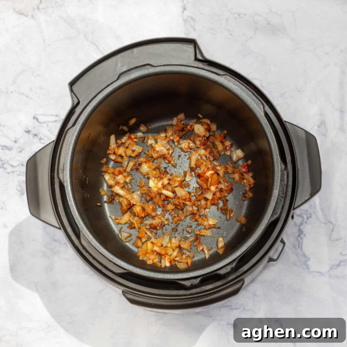 Guilt-Free Delicious Porotos Granados Soup Only 1 Weight Watchers Point 4 Diced onions and minced garlic sautéing in an Instant Pot.