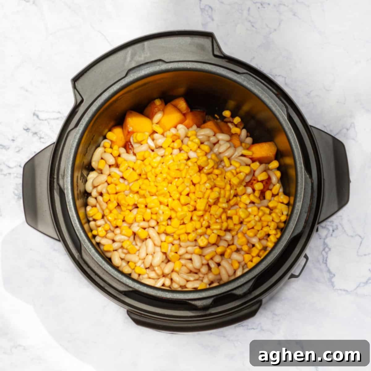 Guilt-Free Delicious Porotos Granados Soup Only 1 Weight Watchers Point 5 Cooked navy beans, corn kernels, and diced pumpkin added to the Instant Pot with sautéed onions and spices.