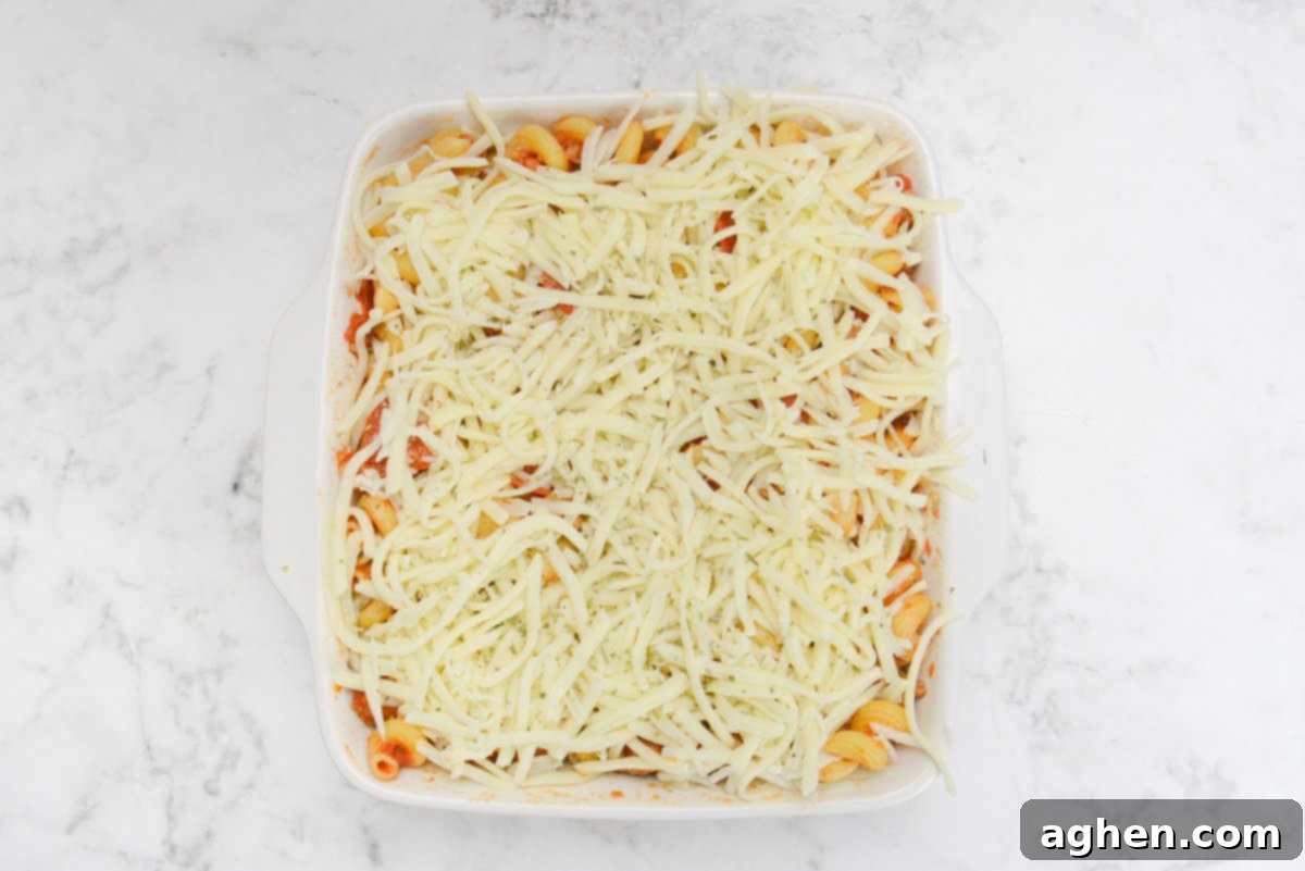 The filled casserole dish is now topped with shredded mozzarella 