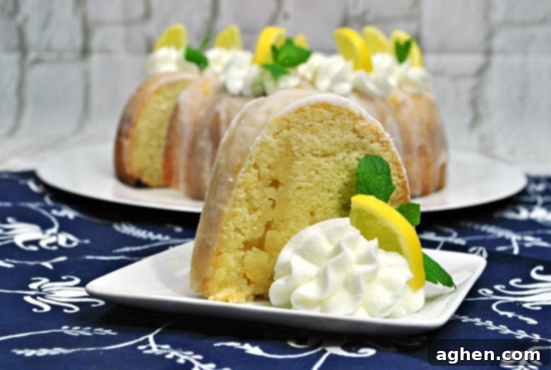 A beautifully baked lemon bundt cake, glistening with a fresh lemon glaze, ready to be served. The perfect combination of sweet and tangy.