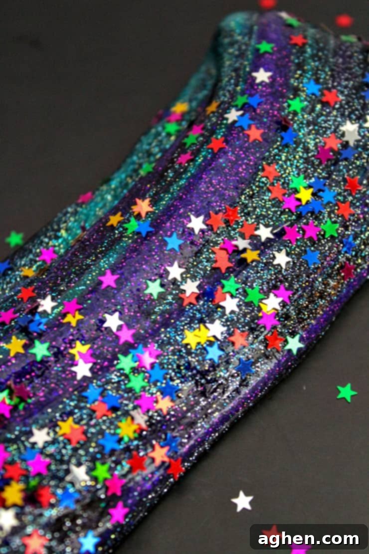 Learn how to make galaxy slime with this easy galaxy slime recipe. The dark colors and glitter combine for DIY slime that is truly out of this world! 