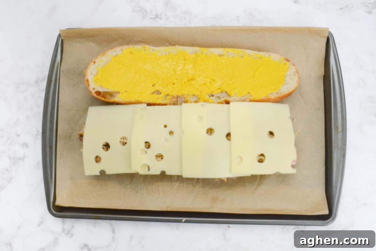 Öğle Yemeğiniz Asla Aynı Olmayacak: Blackstone Küba Sandviçi 7 Swiss cheese slices added to the Cuban Sandwich construction, slightly overlapping.