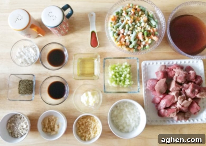 A vibrant display of fresh ingredients laid out for preparing Instant Pot beef stew, including cubed beef, mixed vegetables, potatoes, and various sauces.