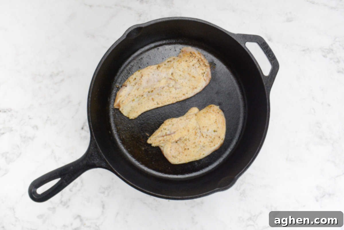 Effortless Delicious Weight Watchers Greek Sheet Pan Chicken 5 A cast iron skillet with seared chicken