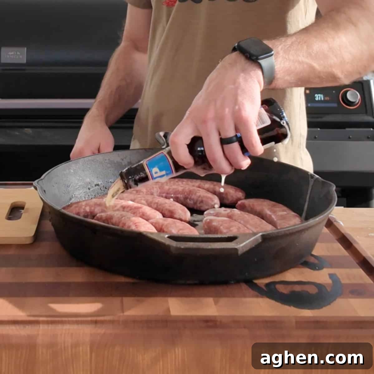 Sausages and sliced onions in cast iron pan with beer