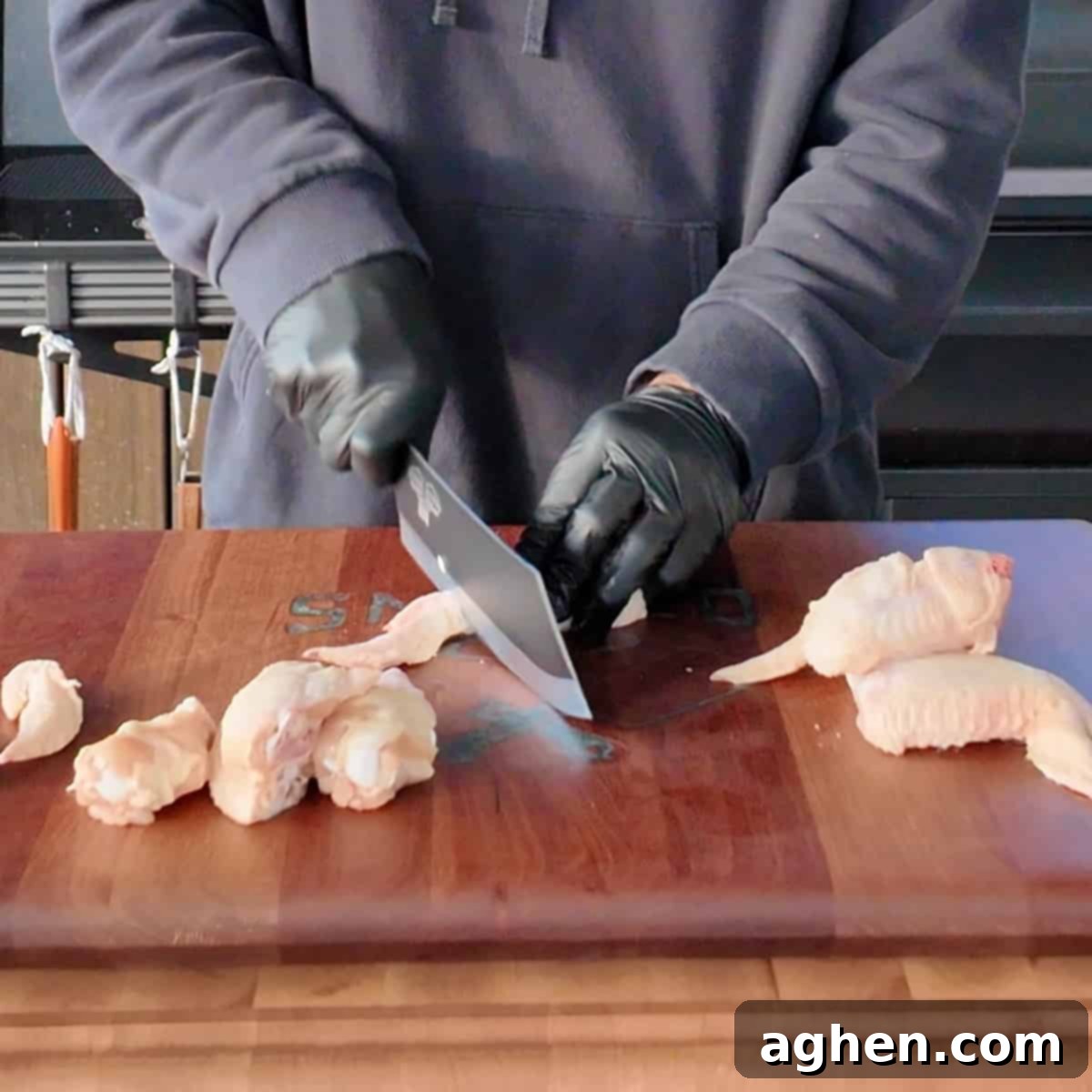Close-up of cutting chicken wings to separate drumettes and flats