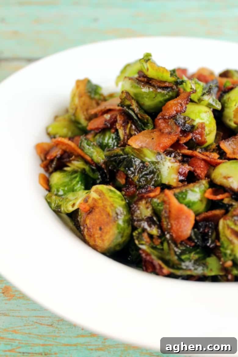 Brussel Sprouts with Bacon and Balsamic Reduction in a white bowl on a wooden table
