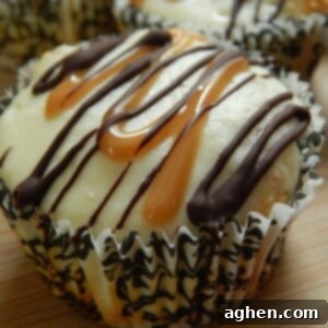 Close-up of a chocolate caramel cheesecake muffin on a wooden surface