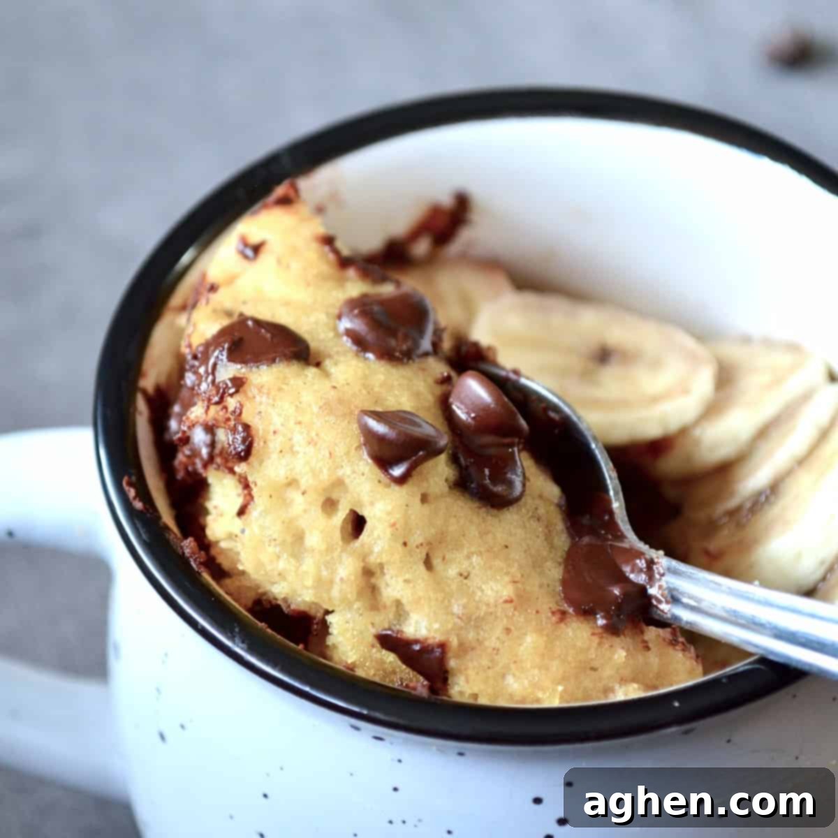 Easy Weight Watchers Banana Chocolate Chip Mug Cake 2 Scooping mug cake with a spoon, highlighting its moist texture