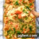 An incredible creamy chicken and rice casserole recipe made with frozen peas and carrots and cream of chicken soup.