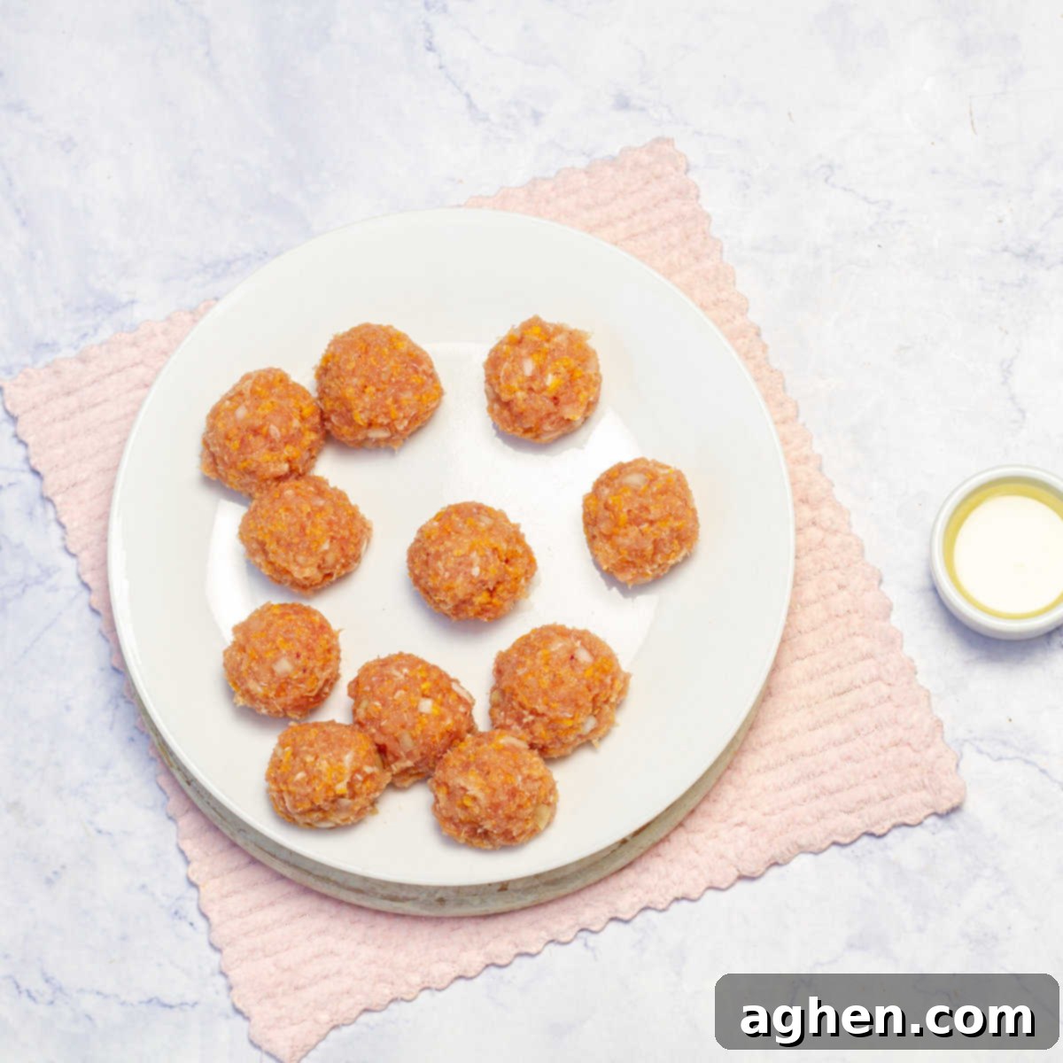 Whip Up Weight Watchers Chicken Meatballs in Just 30 Minutes 5 Uncooked Pesto Chicken Meatballs in a plate