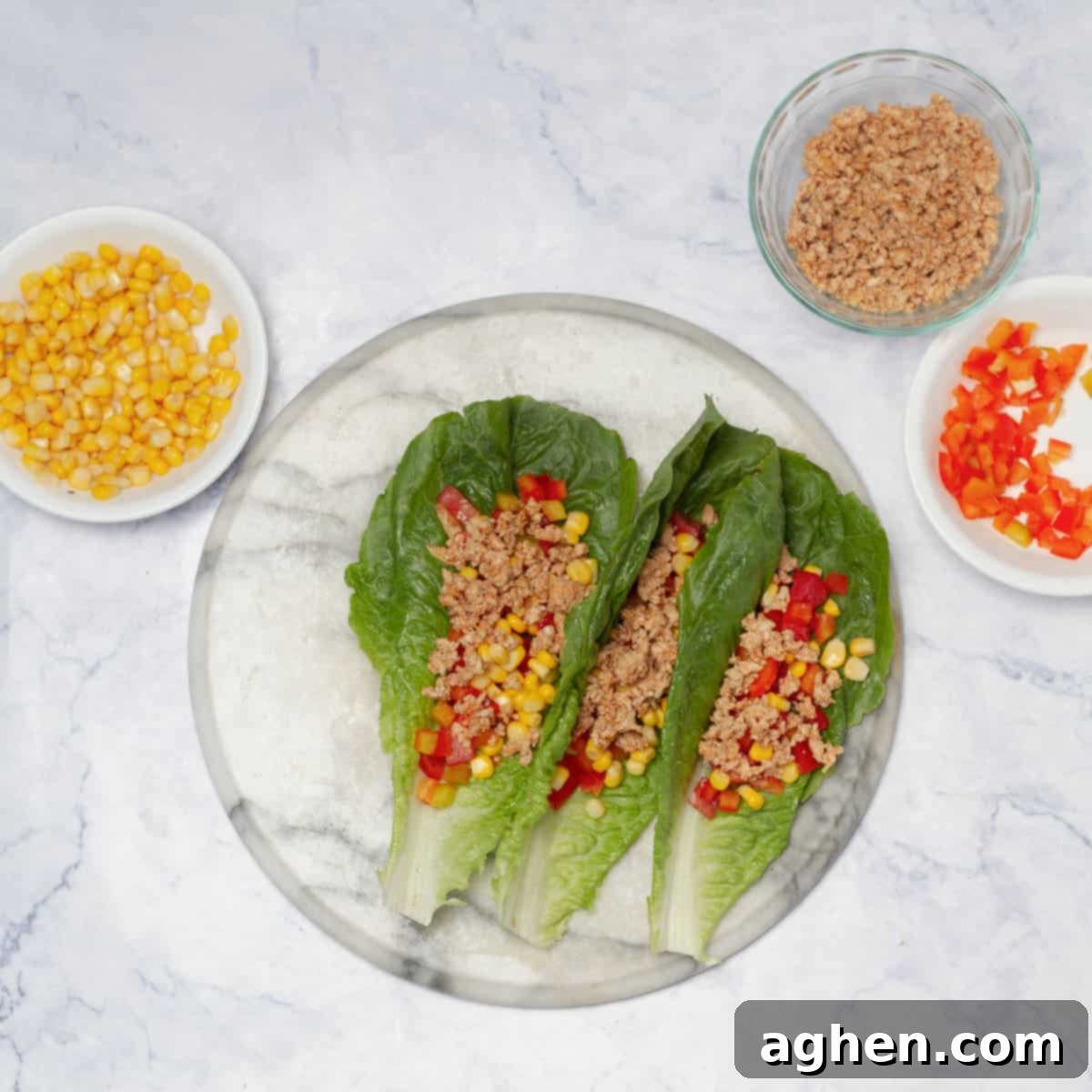 A freshly assembled Turkey Taco Lettuce Wrap on a plate, showcasing its layered ingredients and vibrant colors.