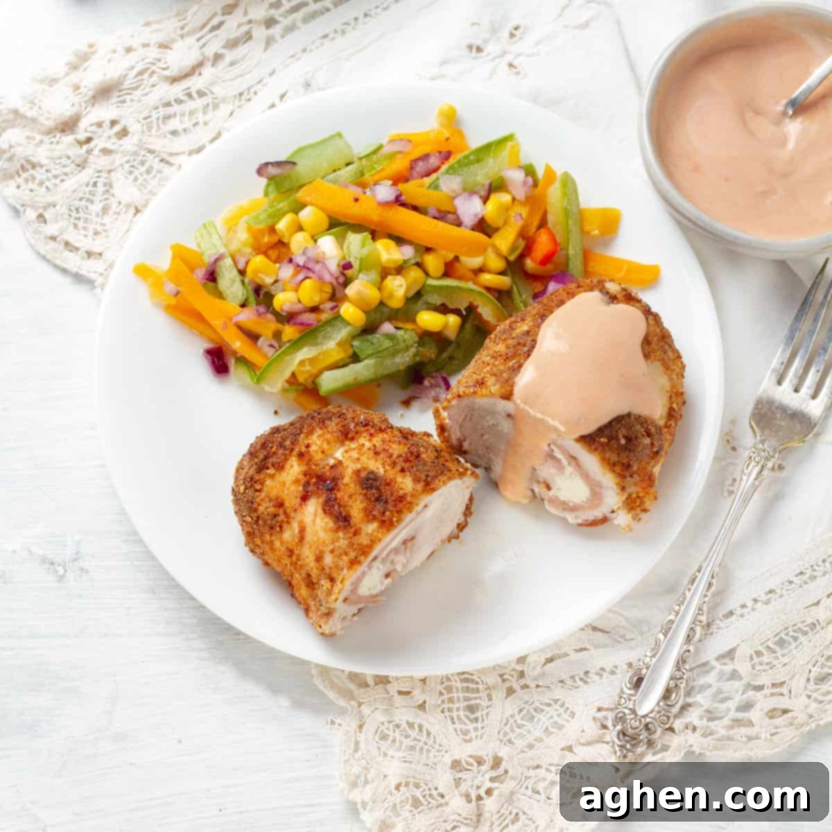 Weight Watchers Chicken Cordon Bleu Reimagined 2 Crispy Air Fryer Chicken Cordon Bleu served with a fresh salad and dipping sauce on a white plate
