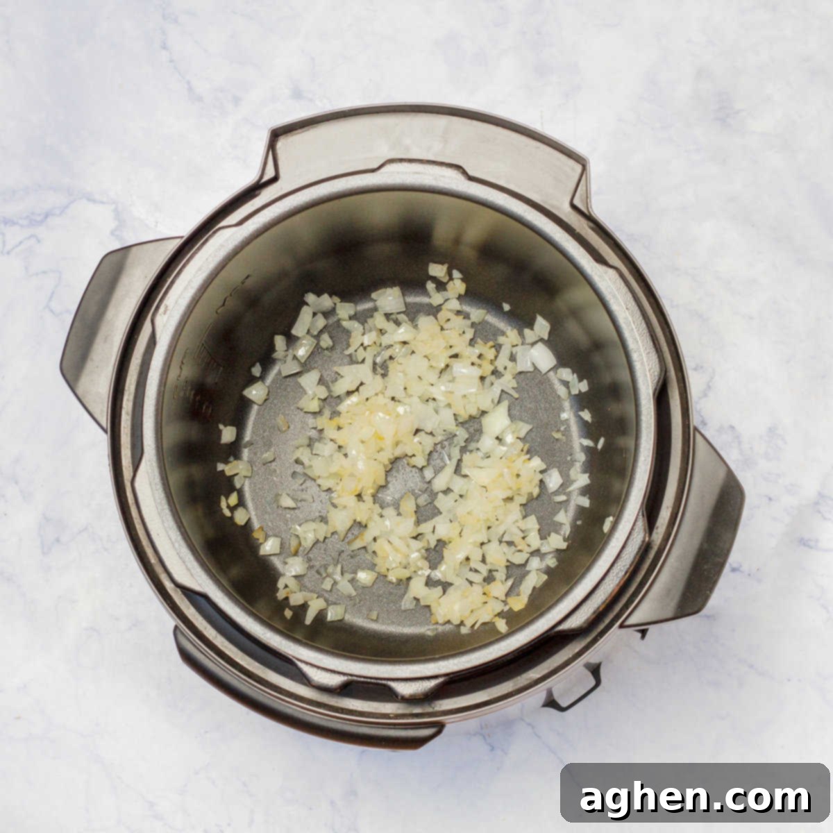 chopped onion and minced garlic sautéing in instant pot